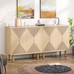 a living room scene with focus on the sideboard and art hanging on the wall