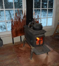 an old fashioned stove in front of a window