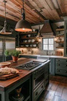 a kitchen with an island and stove top in the center, surrounded by wooden flooring