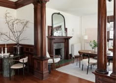 a living room filled with furniture and a fire place next to a mirror on the wall