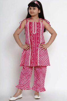 Product Features: Fabric - Top fabric: Pure Cotton. Bottom fabric: Pure Cotton. Description - Pink striped kurta with palazzos. Pink straight knee length kurta, has a square neck, sleeveless, straight hem. Pink printed palazzos, slip-on closure. Disclaimer: There will be slight difference in digital to actual image Striped Kurta, Kurta Skirt, Arab Dress, Kurta Palazzo Set, Kurta Sharara Set, Maha Shivratri, Kids Dress Collection, Kurta Sharara, Kids Winter Fashion