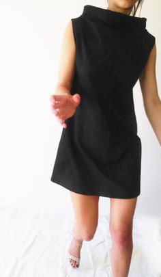 "Description: This little black dress is A-shaped, minimalist, unique and trendy. As fabric is pretty heavy & firm, it accentuates geometrical shape of the dress. It is cut in the middle of the front and the front and back. It has a slightly higher collar. Loose fit flatter any figure. Works great also as a tunic with leggings. Suitable for various occasions (from daytime to formal). Details: Sizes: XS, S, M, L, XL, XXL & 3 XL Care: turn the garment inside out for better washing results, Modern Black Fitted Mini Dress, Modern Black Dresses For Work, Modern Black Mini Dress For Workwear, Modern Black Sleeveless Mini Dress, Fitted Minimalist Dresses For Work, Modern Black Knee-length Mini Dress, Black Fitted Mod Dress, Fitted Minimalist Spring Dress, Minimalist Fitted Spring Dresses