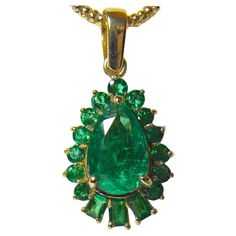 This is a 5.20-carat vibrant AAA green natural Colombian emerald drop pendant necklace crafted in 18K yellow gold. The center emerald is a pear cut weighing over 4.0 carats and is surrounded by 1.20 carats of emeralds. The pendant measurements are 25.00mm x 15.40mm, rising 7.00mm. The average color/clarity is an intense fine green 100% NATURAL color/ clarity VS. **We'll include a chain(different from the ones pictured). 100% Natural Colombian Emeralds and 18K Yellow Gold handmade from our Worksh Emerald Drop Necklace For Formal Occasions, Drop Emerald Necklaces For Formal Occasions, Formal Drop Emerald Necklace, Formal Drop Emerald Gemstone Necklace, Formal Hallmarked Emerald Necklace, Exquisite Oval Green Emerald Necklace, Exquisite Green Oval Emerald Necklace, Green Drop Necklaces In Fine Jewelry Style, Luxury Green Teardrop Pendant Necklace