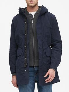 Weatherproof Cotton Windbreaker For Outdoor, Long Cotton Parka With Pockets, Cotton Long Coat Parka With Pockets, Waterproof Cotton Outerwear, Winter Travel Outerwear With Storm Flap, Functional Cotton Outerwear For Work, Weatherproof Cotton Parka For Outdoor, Functional Cotton Windbreaker With Detachable Hood, Cotton Parka With Adjustable Hood For Cold Weather