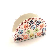 a white and red flowered design ring on a white background