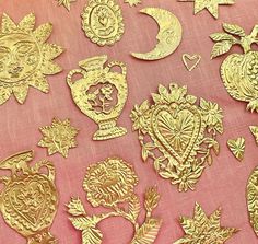 many different types of decorative items on a pink table cloth with stars and moon in the background