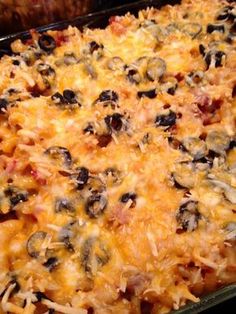 a casserole dish with lots of cheese and black olives