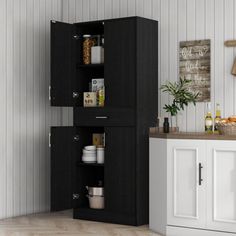 an open cabinet in the corner of a room with white walls and wood flooring