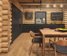 a kitchen and dining area in a log cabin with wood flooring, black appliances and cabinets