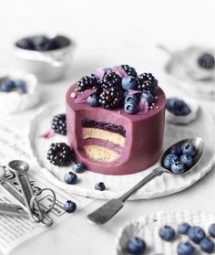 a piece of cake with berries and blueberries on it