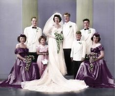 a group of people standing next to each other in front of some columns and pillars