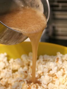 a wooden spoon pouring rice into a yellow bowl