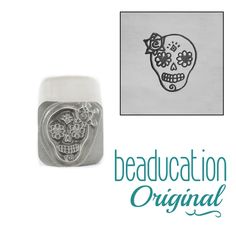 a stamp with a skull and flowers on it, next to the words beaducation original