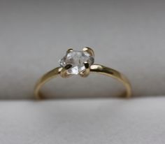 a gold ring with a white diamond in it