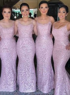 the bridesmaids are posing for a photo in their pink gowns and one is wearing