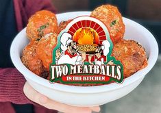 two meatballs in the kitchen logo is displayed on a bowl filled with chicken balls