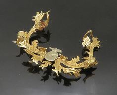 "14K GOLD - Vintage Shiny Antler Style Floral Vine Brooch Pin - GB037  Jewelry Type:         Brooch Pin   Metal Type:            14K Gold   Metal Size:             2.5\" x 2\"   Stone Type:            N/A  Condition:              N/A  Jewelry Weight:     11.8 Grams  PLEASE NOTE: THIS ITEM IS PRE-OWNED. ALTHOUGH MOST ITEMS ARE IN VERY GOOD CONDITION, SOME MAY NEED CLEANING AND/OR MINOR REPAIRS. WE MAKE A VERY STRONG EFFORT TO UPLOAD CLEAR PICTURES. PLEASE INSPECT ALL PICTURES AND ASK ALL QUESTIONS YOU MAY HAVE PRIOR TO MAKING A PURCHASE. NOT ALL STONES ARE GENUINE, SOME ARE ENHANCED OR CREATED." Ornate Carved Gold Brooches, Gold Deer Necklace, Gold Enamel Art Nouveau Brooches, Art Nouveau Yellow Gold Collectible Brooches, Luxury Gold Art Nouveau Brooches, Floral Vine, Antlers, Vintage Watches, All Pictures