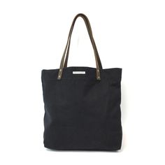 Handcrafted with 100% organic cotton canvas and handles from the finest eco-friendly, vegetable tanned, biodegradable leather. Secure large inside zip pocket with quality YKK metal zipper. This tote is practical while complementing your personal style. MADE BY FREE WOMEN Size: 13" x 5" x 15" Strong 100% organic cotton canvas Sturdy leather handles for easy over the shoulder carrying Large inside YKK metal zipper pocket Comes with a story card explaining the social impact of the product Versatile Canvas Bag With Leather Handles For Everyday Use, Cotton Shoulder Bag With Zipper For On-the-go, Black Cotton Canvas Bag For On-the-go, Waxed Canvas Bag With Leather Handles For On-the-go, Functional Everyday Waxed Canvas Bag, Functional Cotton Bag With Zipper Pocket, Everyday Waxed Canvas Shoulder Bag With Leather Handles, Leather Canvas Bag With Zipper For Daily Use, Cotton Canvas Bag With Silt Pocket For Everyday