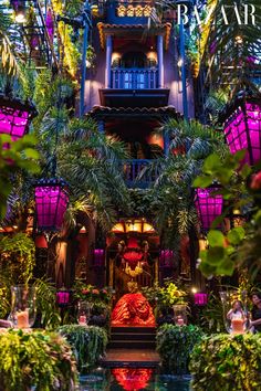 the inside of a building with lots of plants and lights on it's sides