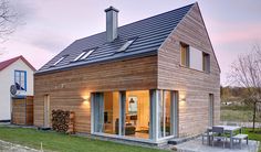 a small wooden house sitting on top of a lush green field