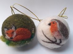 two felt ornaments with animals on them