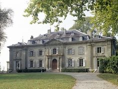 a large house with lots of windows in the front yard