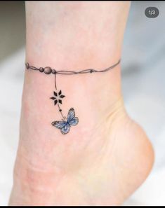 a small tattoo on the ankle of a woman's foot with a blue butterfly