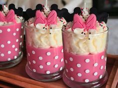 minnie mouse cupcakes in pink and white polka dot cups on a wooden tray