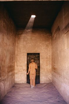 a person standing in an open doorway with their back to the camera