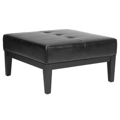 a black ottoman sitting on top of a white floor