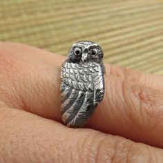 This sterling silver Owl wraps his wing snugly around your finger. He can be your familiar, pet or totem and will protect you with his wing. He is watchful and wary and always on guard. His eyes are set with black diamonds and he makes a perfect totem ring and a great gift for any witch or wizard. The Owl ring was carved in wax. You can see the process video here: https://www.youtube.com/watch?v=shnoxDAeE-4 Then it was cast in sterling silver, hand-polished and covered in patina to make the text Witch Ring, Witch Rings, Bird Ring, Wolf Ring, Sterling Silver Owl, Woodland Jewelry, Owl Ring, Bird Rings, Animal Ring