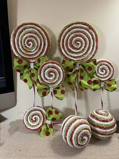 some lollipops are hanging on the wall next to a computer keyboard and monitor