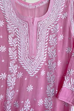 This crepe silk kurta in a soft, pink color is a stunning addition to your wardrobe. Adorned with intricate hand embroidery, it is a one-of-a-kind piece that is sure to turn heads. Complete the look with white straight pants and a white dupatta for a classic, traditional ensemble.     46" length   Long sleeves 20"  Round neck   Crepe silk    Side slits     Dry clean    Chikankari embroidery     Hand embroidered    Fit:    True to size  Inside Margin:    No  Touch and Feel:  Soft and Comfortable Dispatched in 1-3 business days White Straight Pants, Phulkari Pants, Lucknowi Kurta, White Dupatta, Patiala Salwar Suits, Chikankari Embroidery, Chikankari Kurta, Bridal Dupatta, Phulkari Dupatta