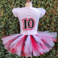 This Stranger Things Custom Outfit features a cotton shirt with a Stranger Things Hellfire Club theme in red, black, and white. Perfect for a unique and memorable birthday look, or for showing your appreciation of the show. White Cotton Tops For Fan Events, Red Fitted Tops For Cheerleading, Fitted Red Tops For Cheerleading, White Fitted T-shirt For Birthday, Red Fitted Top For Birthday, Fitted Red Top For Birthday, Fitted White T-shirt For Cheerleading, Fitted White Top For Birthday, Red Cotton Party T-shirt