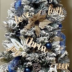 a christmas tree decorated with blue and silver decorations