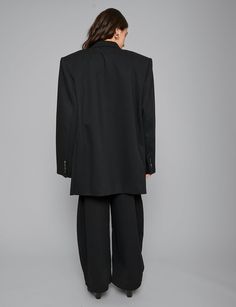 Oversized black blazer with padded dropped shoulders. Styled with matching barrel pants. 62% polyester, 35% viscose, 3% spandexFully linedFit is oversized Double Button closure Button sleeve cuffFront slit pocketsFaux chest pocketTotal length 32"/ 81 cmChest 42"/ 107 cm Extra padded shoulders Model is wearing one size and model's height is 5.8"/172cm Imported Oversized Blazer Black Outfit, Oversized Black Blazer Outfit, Blazer Photoshoot Women, 1st Photoshoot, Oversized Black Blazer, Womens Oversized Blazer, Barrel Pants, Black Blazer Outfit, Spring 2025