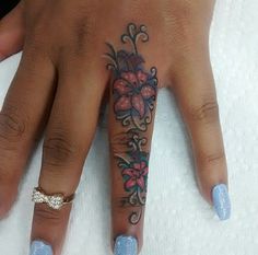 a woman's hand with a tattoo on it