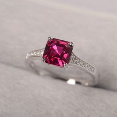 ◆ Hand-finished in Sterling sliver, this piece features a Asscher shaped ruby. Clear zirconia stones decorate half of the ring shank. A piece of classic, it is suitable for engagement, party, daily occasion. ◆ Production Description: Main stone Type: Lab Ruby Main Stone Shape: Asscher Main Stone Size: 7*7mm Side stone: CZ Metal: 925 Sterling silver - Other options available in the drop down menu ◆ Customization: √Free for Add Engraving √Other Metal Type Available √Other Gemstones & Shapes Av Asscher Cut Ruby Jewelry With Center Stone, Formal Ruby Birthstone Ring With Accent Stones, Asscher Cut Ruby And Diamond Ring, Asscher Cut Diamond Ruby Ring With Prong Setting, Asscher Cut Ruby Fine Jewelry, Formal Asscher Cut Ruby Ring, Fine Ruby Birthstone Ring With Accent Stones, Asscher-cut Ruby Gemstone Ring, Asscher Cut Ruby Ring Fine Jewelry