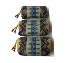 I made this trio of pouches from a wool print that Pendleton Woolen Mills calls "American Treasures". The largest pouch measures about 9" x 5" x 2.25". The middle pouch measures 8" x 4" x 2". The smallest pouch measures 6" x 3.5" x 1.25". I used a quality zipper across the top of the pouches with  zipper pulls I made from soft yellow deer leather and glass crow beads. None of my smaller pouches are lined. The blanket weight wool is reversible and with all seams completely finished, the inside is as beautiful as the outside. This set of zippered pouches would be great for keeping your purse, suitcase or office drawer organized. They will pack together with the smaller 2 pouches fitting into the larger one making the set perfect for traveling to use as needed.  This gift set includes a gift Office Drawer Organization, Pendleton Oregon, Office Drawer, Pendleton Woolen Mills, Large Pouch, Pendleton Wool, Purse Organization, Soft Yellow, Small Pouches