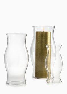 three glass vases and one candle holder