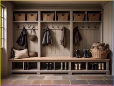 a wooden bench sitting next to a wall filled with baskets and coats on top of it