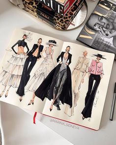 an open book with fashion illustrations on it next to a pen and scissors, some books