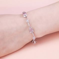 Surround her with flowers all year long. Buy that special someone this silver flower bracelet, whether she is celebrating a holiday or if she is just a lover of flowers. Crafted in two tone sterling silver, this bracelet features a beautiful tulip in bloom, with a pink pear-shaped stones and silver chain. This bracelet can be easily resized to fit her wrist, allowing for different looks. This charming bracelet will surprise her.Carat Weight: 3.945 ctStone Size: 1.5*3,2*4,5*7 mmStone Type: Jeulia Charming Bracelet, Silver Flower Bracelet, Design Bracelet, Tulip Design, 925 Silver Bracelet, Flower Bracelet, Pink Stone, Silver Flowers, Pear Cut