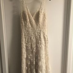 a white dress hanging on a wall