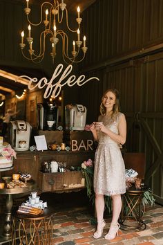 a woman standing in front of a coffee bar