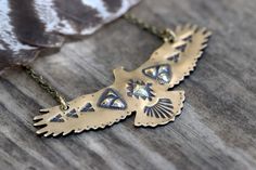 "This listing is for one hand stamped brass hawk necklace. Wear this bohemian necklace to show your affinity and love for all things natural, spiritual, and sky-bound. It is a powerful and eye-catching piece. - Hawk is made from 18 gauge brass sheet metal. This is a sturdy piece- it is not flimsy. - Pendant measures 3\" by 1 1/4\" (75mm by 30mm) - Chain in photo measures 16\" from end to end, but can be lengthened to your preference. Choose at check-out! Also, I can suspend it on black or brown Thunderbird Jewelry, Thunderbird Necklace, Unique Bird Design Pendant Jewelry, Eagle Necklace, Gold Statement Necklace, Bird Necklace, Bird Pendant, Southwestern Jewelry, Big Bird