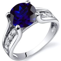 a ring with a blue stone surrounded by white diamonds