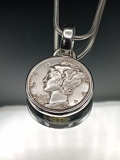 a silver coin is hanging from a chain