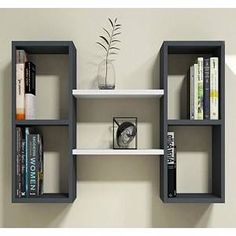 three shelves with books and plants on them