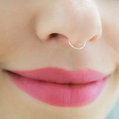 a woman's nose with a small nose ring on top of her nose,